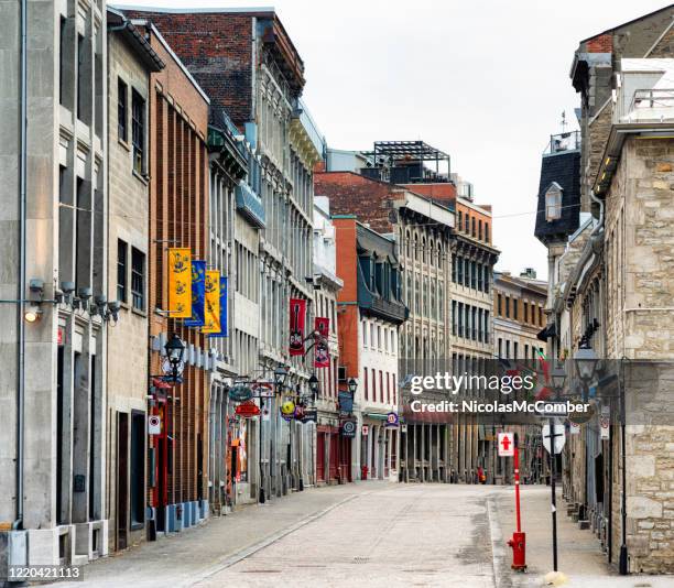 deserted old montreal street scene on a cloudy springtime day - old montreal stock pictures, royalty-free photos & images