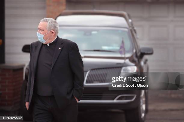 Chaplain Fr. John McNalis attends the funeral of Firefighter Edward Singleton, a 33 year veteran of the Chicago Fire Department, on April 22, 2020 in...