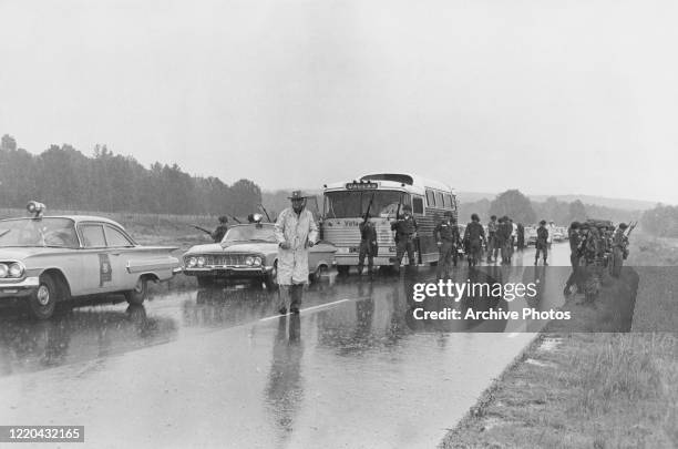 The military guard a bus en route from Montgomery, Alabama, as civil rights activists known as the Freedom Riders head for Jackson, Mississippi, 26th...