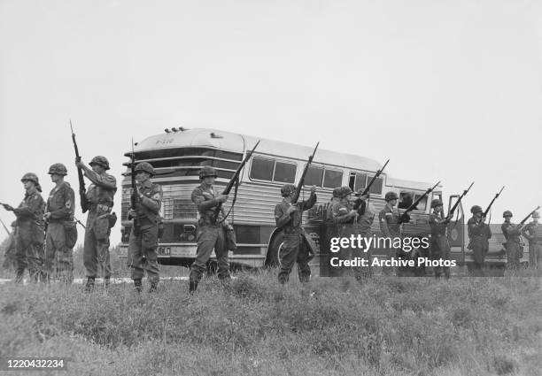 The military guard a bus en route from Montgomery, Alabama, as civil rights activists known as the Freedom Riders head for Jackson, Mississippi, 26th...
