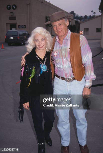 American astronaut Buzz Aldrin and his wife, Lois Driggs Cannon , both dressed in country and western attire, attend an event, circa 1990.