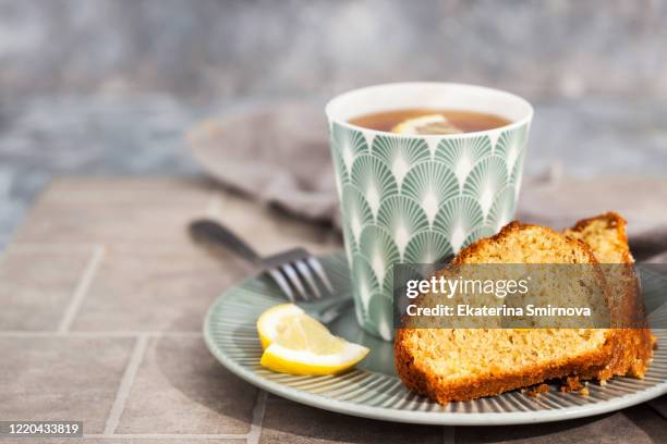 lemon cake slices and cup of hot black tea - bundt-cake stock pictures, royalty-free photos & images