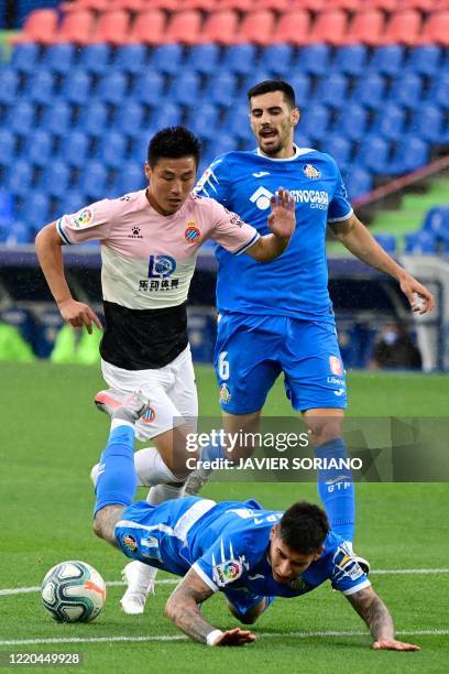 Espanyol's Chinese forward Wu Lei challenges Getafe's Uruguayan defender Mathias Olivera during the Spanish league football match Getafe CF against...