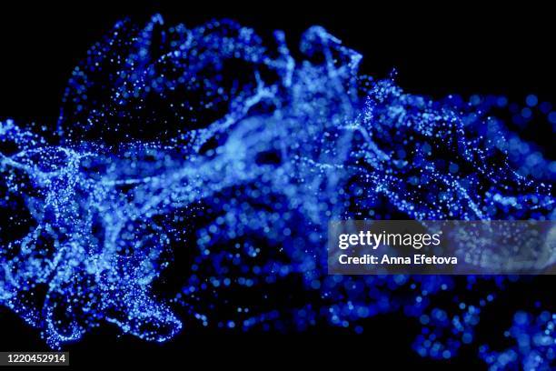 splash of particles on black background - molecules of water stock pictures, royalty-free photos & images