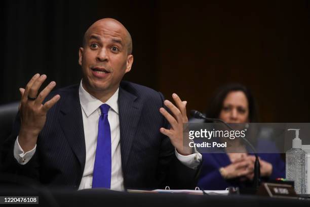 Senator Cory Booker speaks as Sen. Kamala Harris looks on during a Senate Judiciary Committee hearing to examine issues involving race and policing...