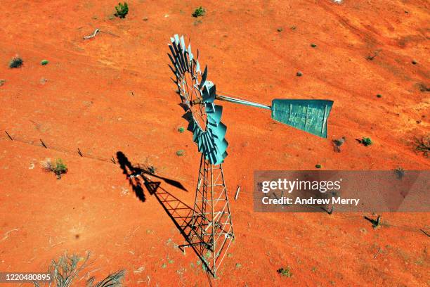 windmill, water windpump on farm with dry red dirt field, australia, aerial view - outback windmill bildbanksfoton och bilder