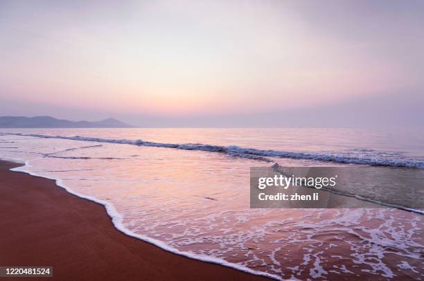 the beach at sunrise - qingdao beach stock pictures, royalty-free photos & images