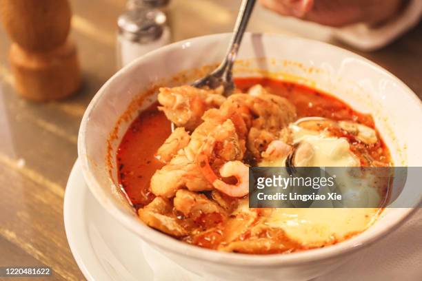 close-up view of classic swedish fish soup served with prawns, clams & aioli, stockholm, sweden - aioli stock-fotos und bilder