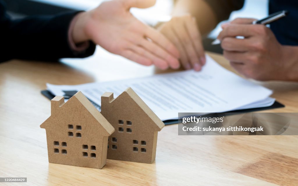 Customer signing a real estate contract in real estate agency.Concept mortgage,home purchase contract.