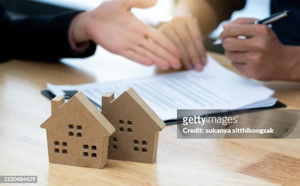 customer signing a real estate contract in real estate agency.concept mortgage,home purchase contract. - construction contract stock pictures, royalty-free photos & images