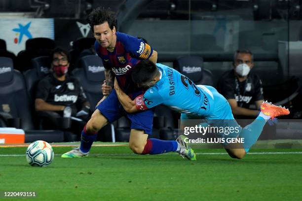 Barcelona's Argentine forward Lionel Messi is tackled by Leganes' Spanish defender Unai Bustinza during the Spanish league football match FC...