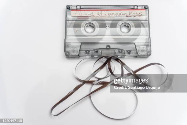 close-up of old  audio cassette tape with loose tape spilling out - tape stockfoto's en -beelden