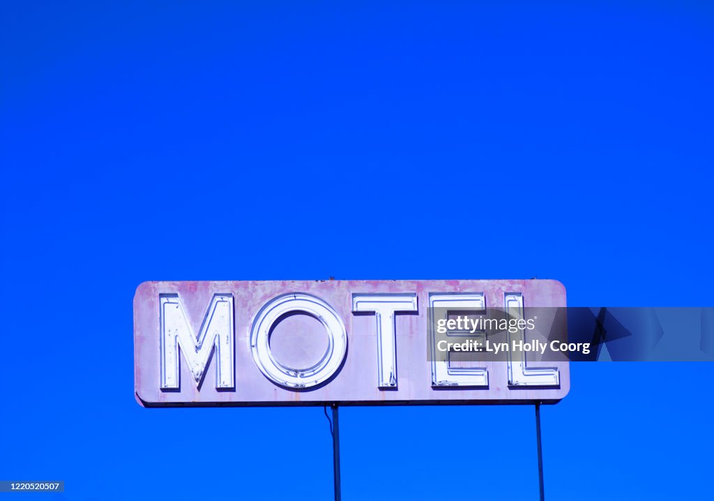 Motel sign against blue sky