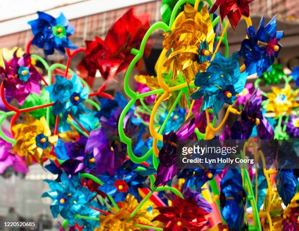 coloured children plastic windmills - lyn holly coorg stockfoto's en -beelden