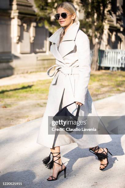 Caroline Daur, wearing a grey coat, black Prada bag and black heels, is seen outside Elie Saab, during Paris Fashion Week - Haute Couture...