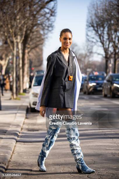 Model Cindy Bruna, wearing a grey checked decorated blazer and denim boots, is seen outside Elie Saab, during Paris Fashion Week - Haute Couture...