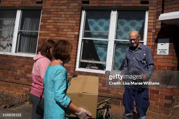 Jess Proctor and Dr Jane Carrick, volunteers at St Paul's Anglican Church Parish Pantry deliver an essential food pack to local resident Peter on...