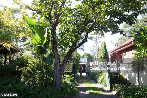 Two men carry essential food packs after visiting the St Paul's Anglican Church Parish Pantry on April 23, 2020 in Sydney, Australia. The Parish...