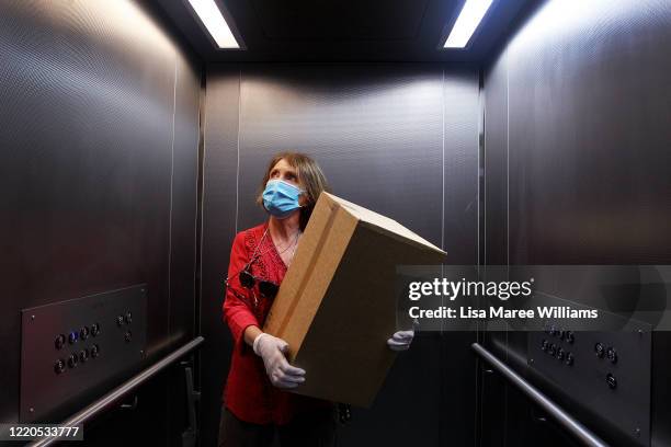 Dr Jane Carrick a volunteer at St Paul's Anglican Church Parish Pantry delivers an essential food pack to residents in need on April 21, 2020 in...