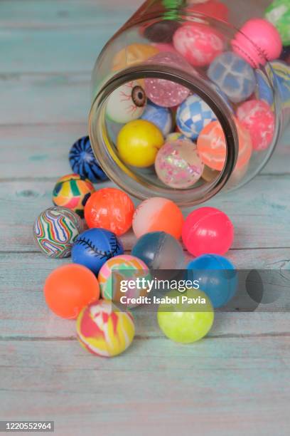 toy balls in glass jar - balls bouncing stock pictures, royalty-free photos & images