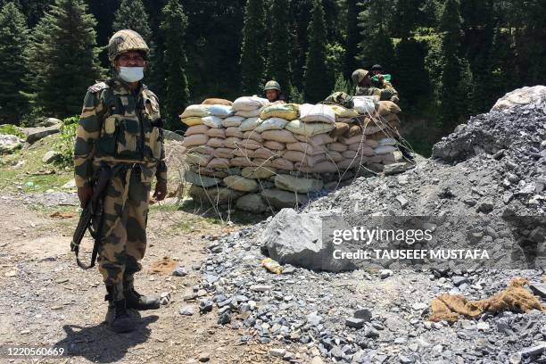 Indian Border Security Force soldiers guard a highway leading towards Leh, bordering China, in Gagangir on June 17, 2020. - The long-running border...