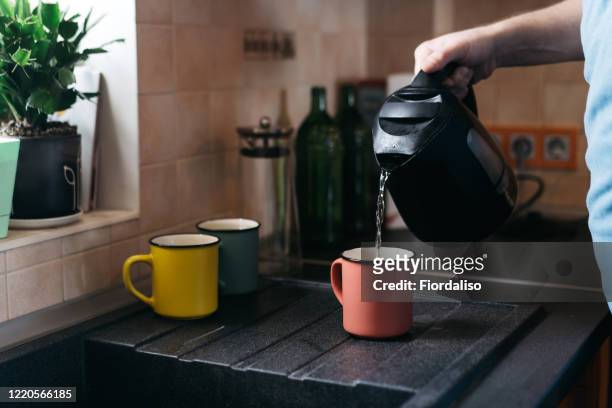 a man preparing homemade coffee for breakfast - boiling kettle stock pictures, royalty-free photos & images