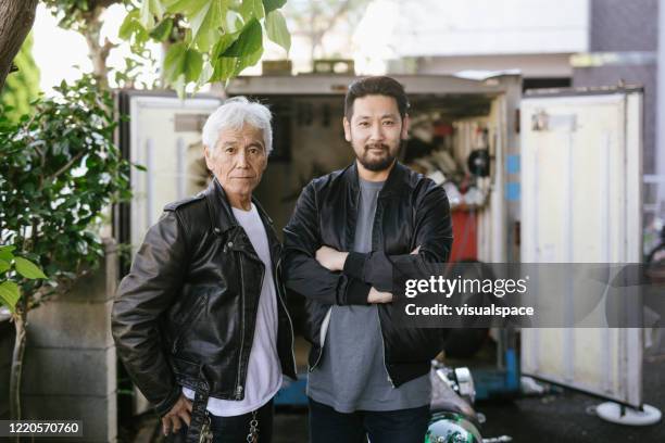 porträtt av senior asian man med sin son - cool man leather bildbanksfoton och bilder