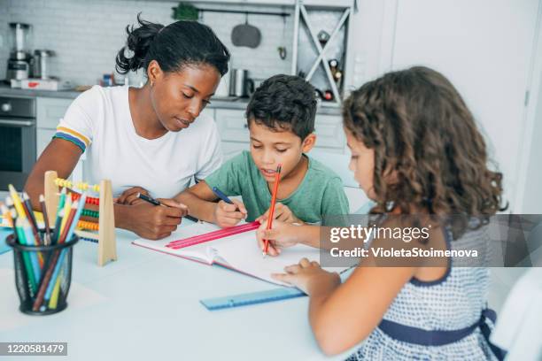happy kids doing their homework with mom. - home school stock pictures, royalty-free photos & images