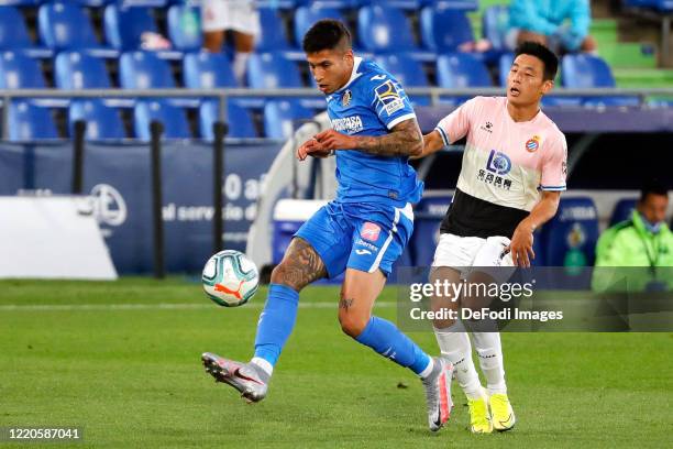 Mathias Olivera of FC Getafe and Wu Lei of Espanyol Barcelona battle for the ball during the Liga match between Getafe CF and RCD Espanyol at...