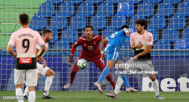 Angel Rodriguez of FC Getafe and Diego Lopez of Espanyol Barcelona battle for the ball during the Liga match between Getafe CF and RCD Espanyol at...