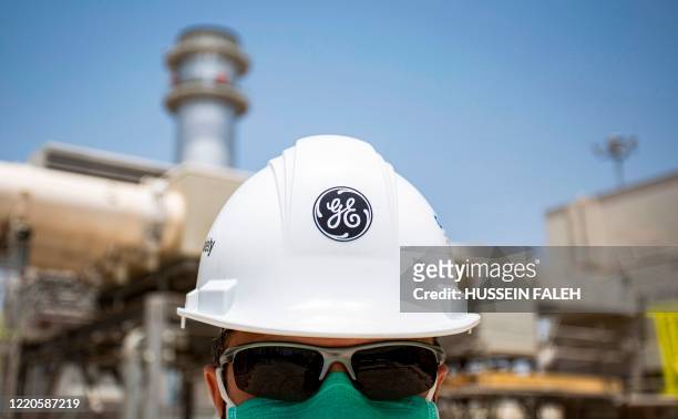 Mask-clad General Electric employee tours the Dhi Qar Combined Cycle Power Plant near the Iraqi city of Nasiriyah on June 15, 2020.
