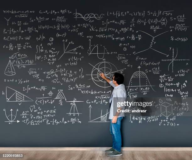 math teacher writing formulas on a blackboard - physics stock pictures, royalty-free photos & images