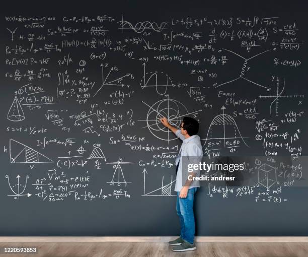 math teacher writing formulas on a blackboard - physics equation stock pictures, royalty-free photos & images