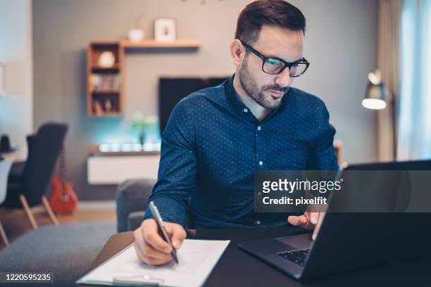 worried businessman checking financial numbers - using computer stock pictures, royalty-free photos & images