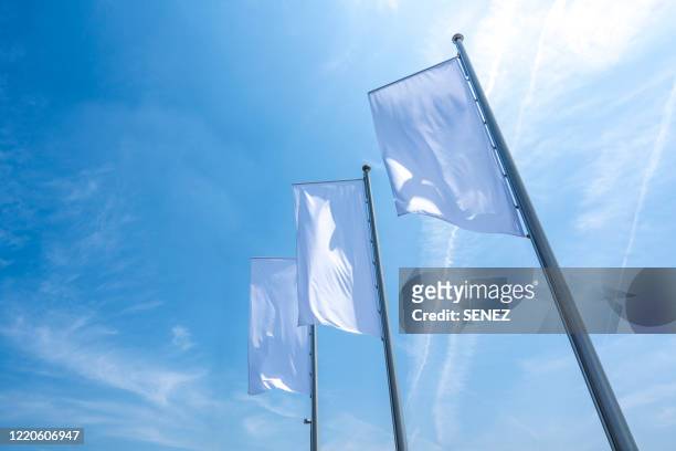 low angle view of white flag - white flag stockfoto's en -beelden