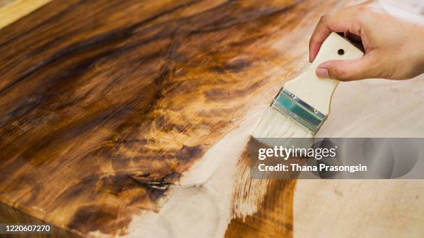 staining wood with paintbrush - teak wood material photos et images de collection