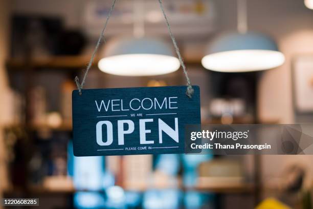 store open sign hanging on the window - letrero de tienda fotografías e imágenes de stock