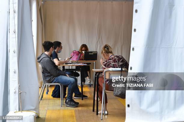 High school student pass the Baccalaureat examination on June 17, 2020 under a tent set up in the yard at the J. F. Kennedy High School in Rome, as...