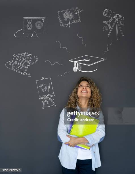 happy student thinking about what to study - college student thinking stock pictures, royalty-free photos & images