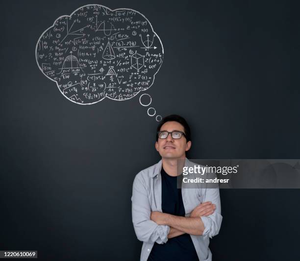 young mathematician thinking about equations - mathematician stock pictures, royalty-free photos & images