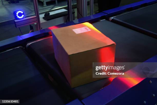 automatic sensor scanning at logistics factory's conveyor belt - scanner stock stock pictures, royalty-free photos & images