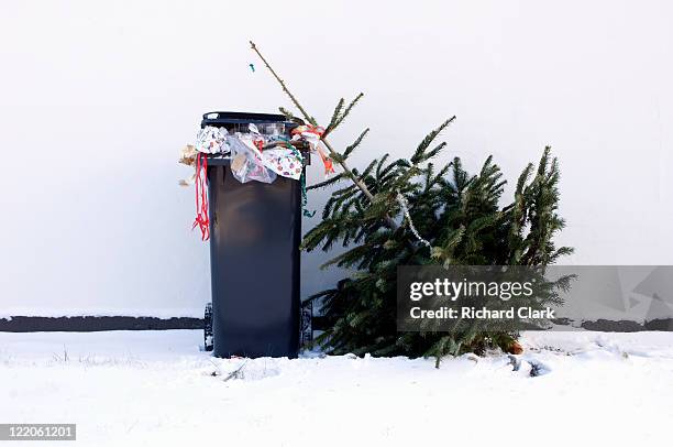 bin full of christmas waste and tree - vuilnisbak stockfoto's en -beelden