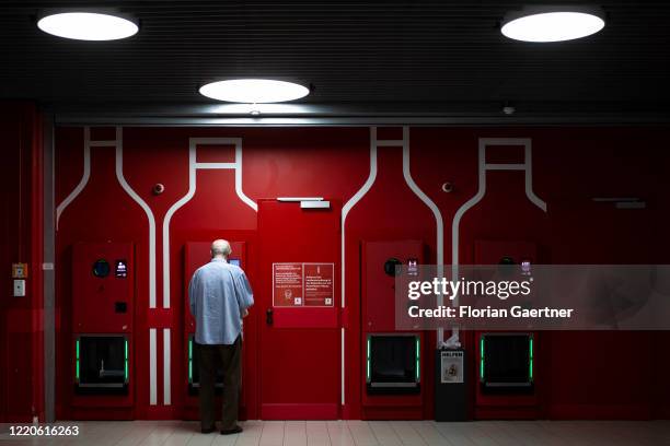 An old man is pictured in front of a reverse vending machine on June 16, 2020 in Berlin, Germany.