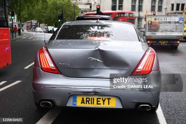 Large dent in the car of Britain's Prime Minister Boris Johnson is seen after an incident where a protester runs into the road toward the convoy and...