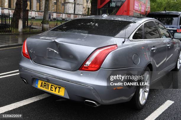 Large dent in the car of Britain's Prime Minister Boris Johnson is seen after an incident where a protester runs into the road toward the convoy and...