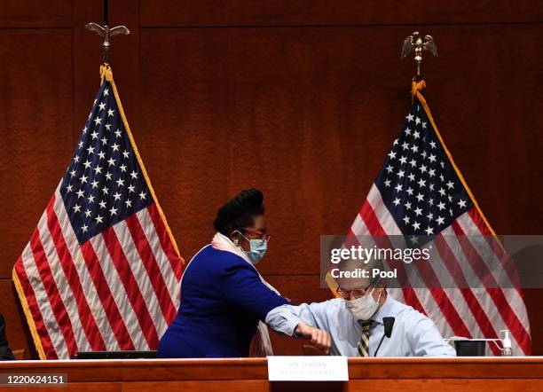 Rep. Jim Jordan and Rep. Sheila Jackson Lee greet by bumping elbows at a House Judiciary Committee markup of H.R. 7120, the "Justice in Policing Act...