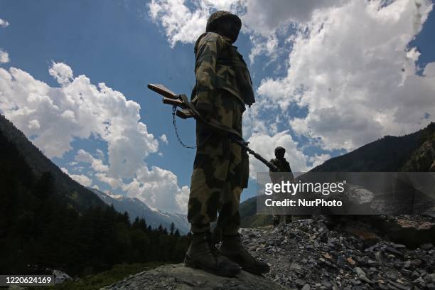 Indian border security force soldiers keeping vigil near a military bunker along the Srinagar-Leh National highway on June 17, 2020.At least 20...