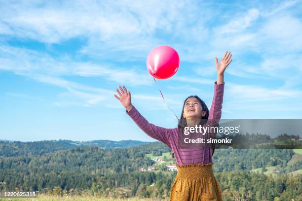 girl releasing balloon - releasing balloon stock pictures, royalty-free photos & images