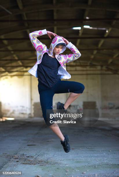 hip hop female dancer jumping and dancing - hip hopper stock pictures, royalty-free photos & images