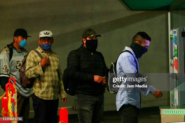 Passengers wear protective masks while buying a ticket for the subway train on April 20, 2020 in Guadalajara, Mexico. Mexico started what the...